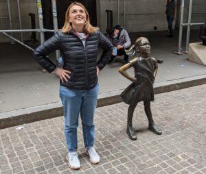 La estatua de la niña y Silvia en la misma postura desafiando a la Bolsa de Nueva York